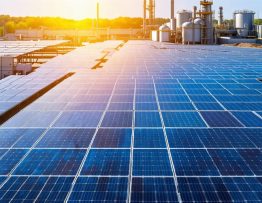 Expansive solar panel array integrated within an industrial complex, symbolizing the rise of solar energy in industrial sectors.