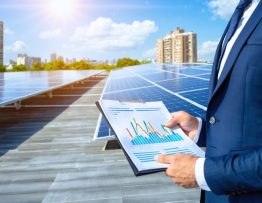A modern commercial building with a rooftop solar panel installation and a business professional holding a financial report, showcasing the financial benefits and sustainability of solar energy.