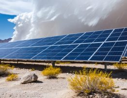 Conceptual representation of resilient solar energy systems showcasing robust solar panels, inverters, and energy storage against challenging weather conditions like high winds and desert heat.