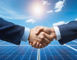 An illustration of a government official and a business executive shaking hands over a solar installation, symbolizing the collaboration between public and private sectors in solar energy innovation.