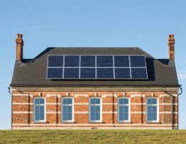 An illustration showing a historic heritage building with solar panels integrated into its roof, highlighting the balance between preservation and modern energy solutions.