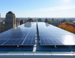 Aerial view of solar panels on commercial rooftops in Washington, DC, highlighting the city's commitment to renewable energy transformation.