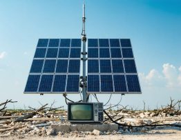 Solar panels powering an FM transmitter in a post-disaster environment, showcasing reliable communication through renewable energy.