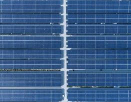 "Aerial view of a large commercial rooftop with solar panels and digital overlay effects representing smart energy management."