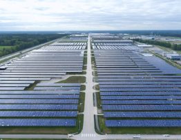 "Aerial view of an industrial facility with solar panels and heat recovery systems demonstrating sustainable energy technologies."