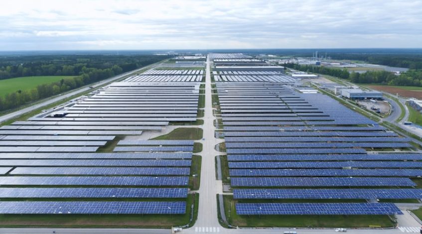 "Aerial view of an industrial facility with solar panels and heat recovery systems demonstrating sustainable energy technologies."
